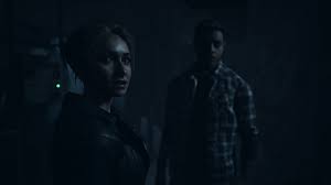 Two Until Dawn 2 characters standing in a dark room